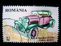 A stamp printed in Romania shows an image of a Pink Ford Spider 1930 classic car.